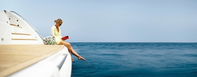 Woman-reading-a-book-on-a-yacht